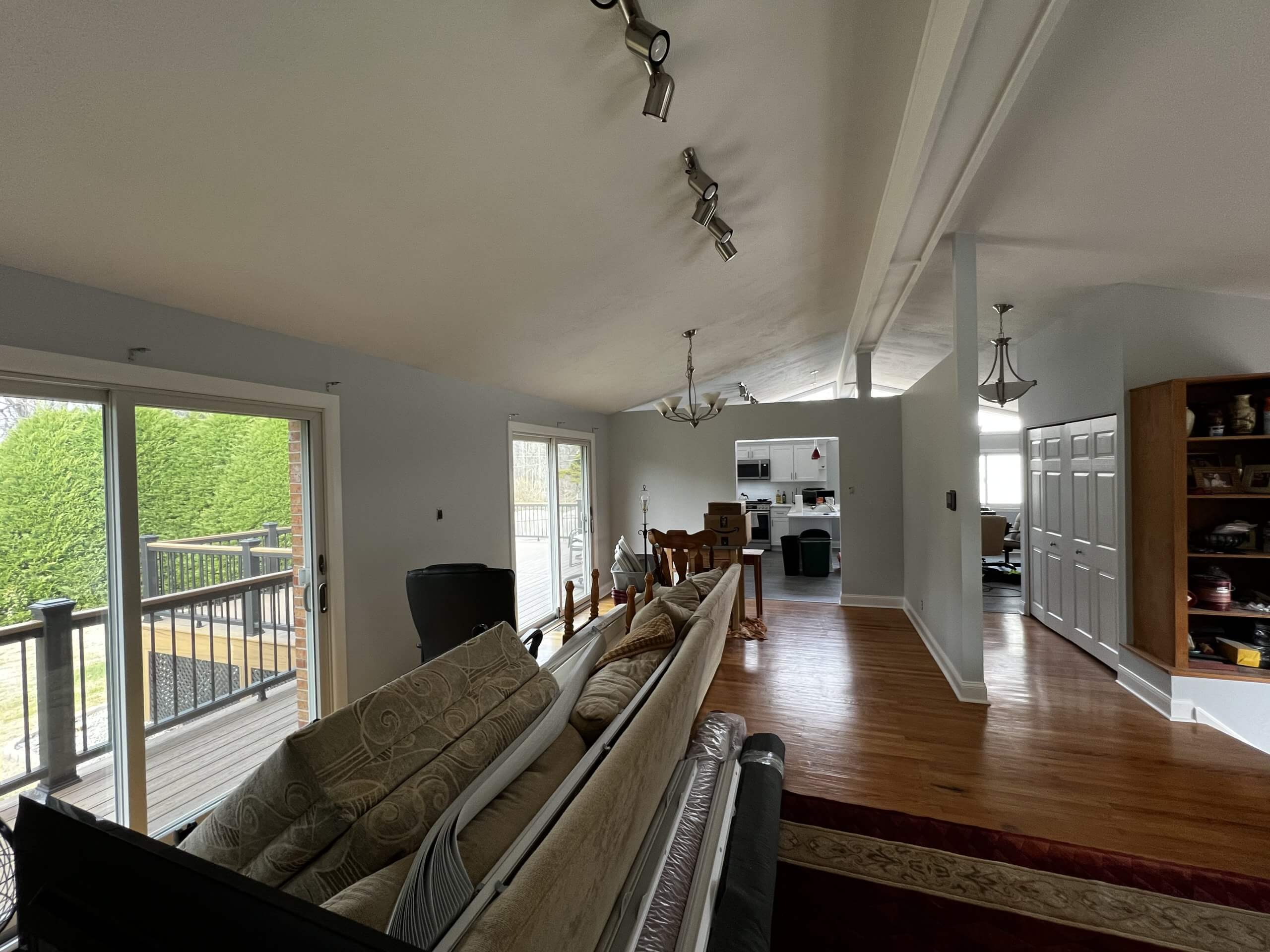 Spacious living room with hardwood floors and outdoor deck access.